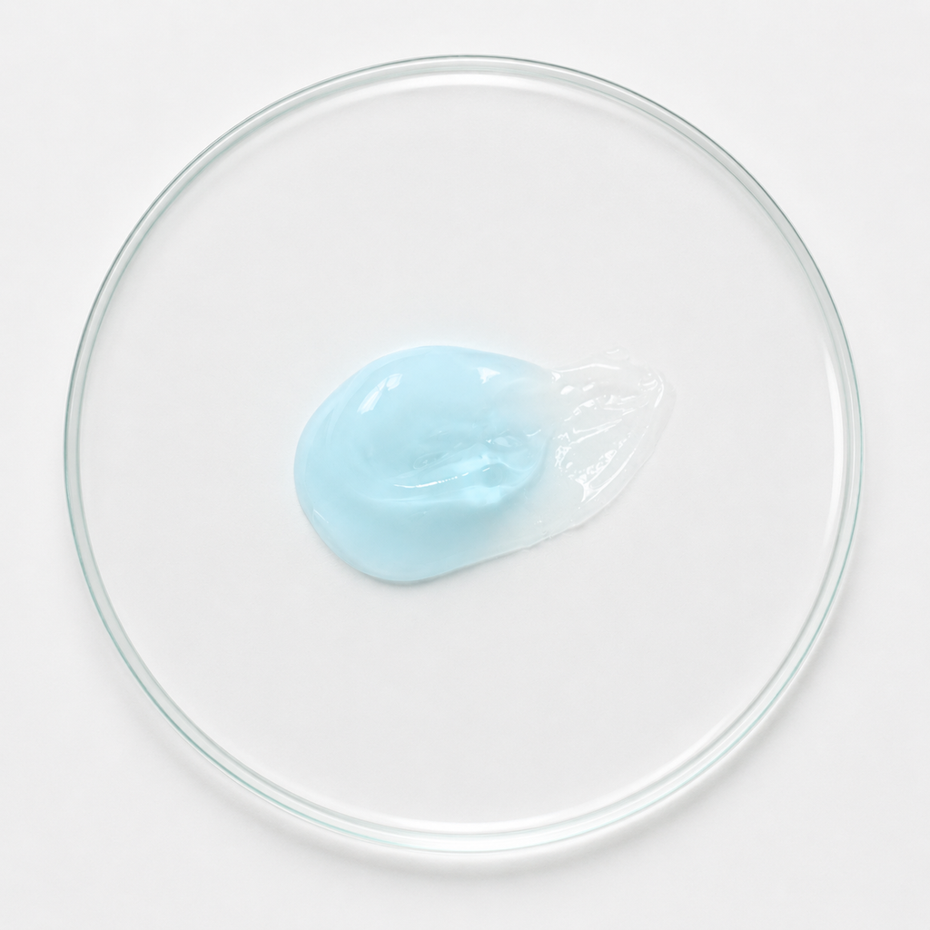 Clear glass bowl with a small blue jelly-like substance on a white background